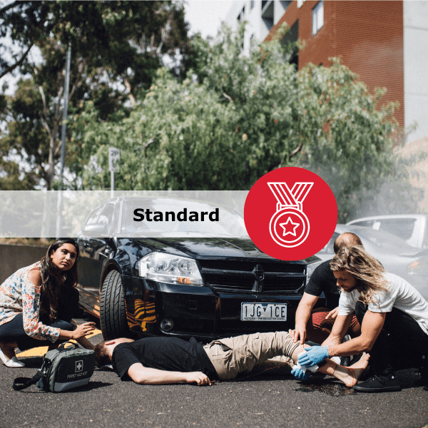 People providing first aid in a simulated car accident.